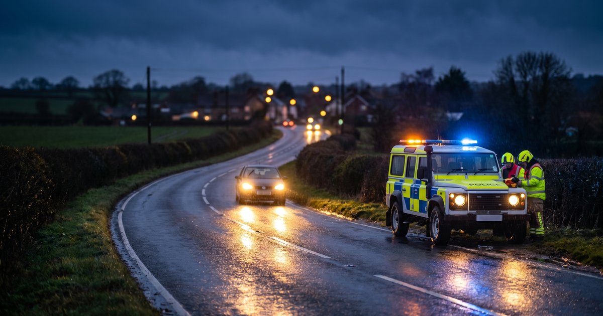 Evening driving safety - UK road at dusk with car headlights